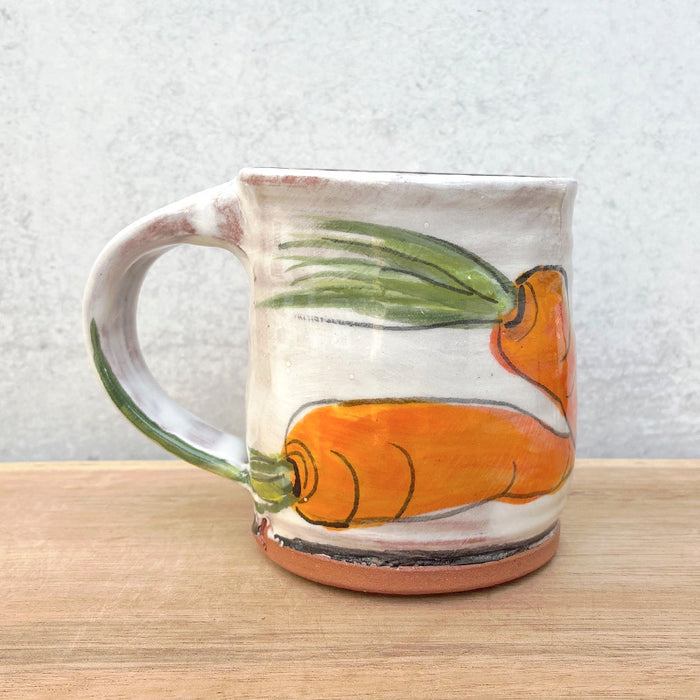 Handmade ceramic mug by NC potter Molly Lithgo. White with carrot  decoration. 