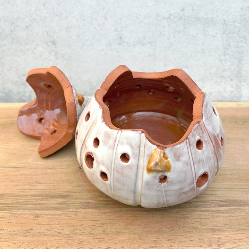 Handmade ceramic garlic keeper jar by Molly Lithgo, shaped like a garlic bulb. Open view shown.