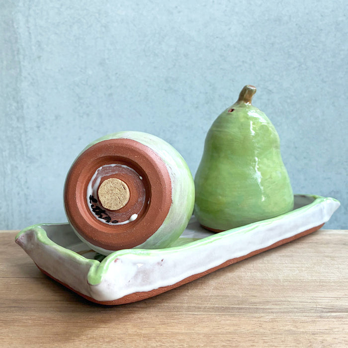 Ceramic pear salt and pepper shaker set with rectangle tray by Molly Lithgo. Alternate view showing the bottom of one shaker. 