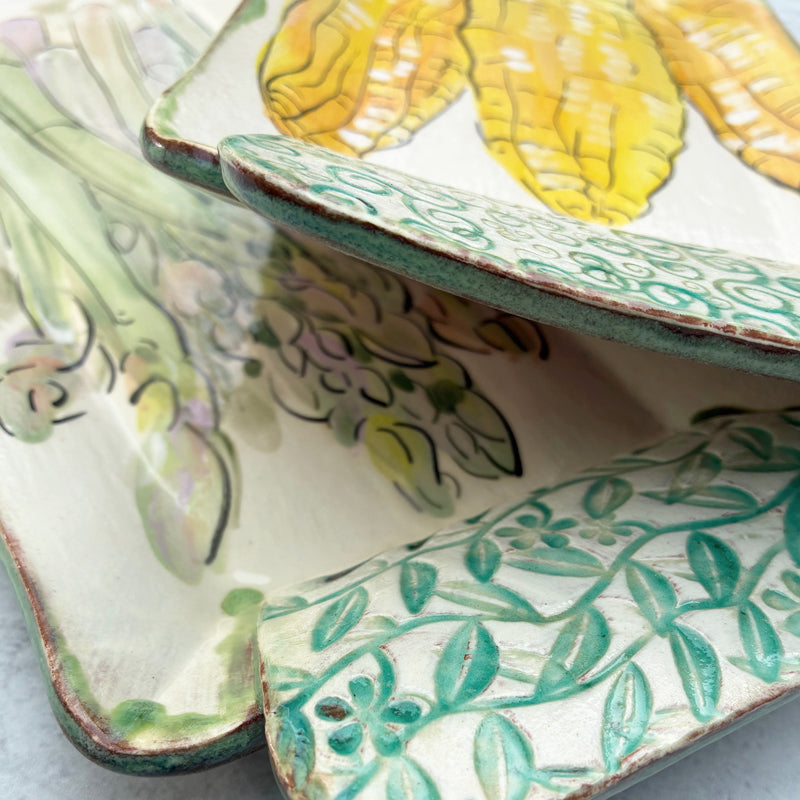 Handmade ceramic serving trays by Molly Lithgo, two tray details with asparagus and corn decoration. 