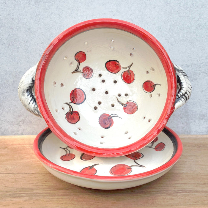 Handmade ceramic berry bowl and saucer with cherry decoration by Molly Lithgo. Interior and saucer view. 