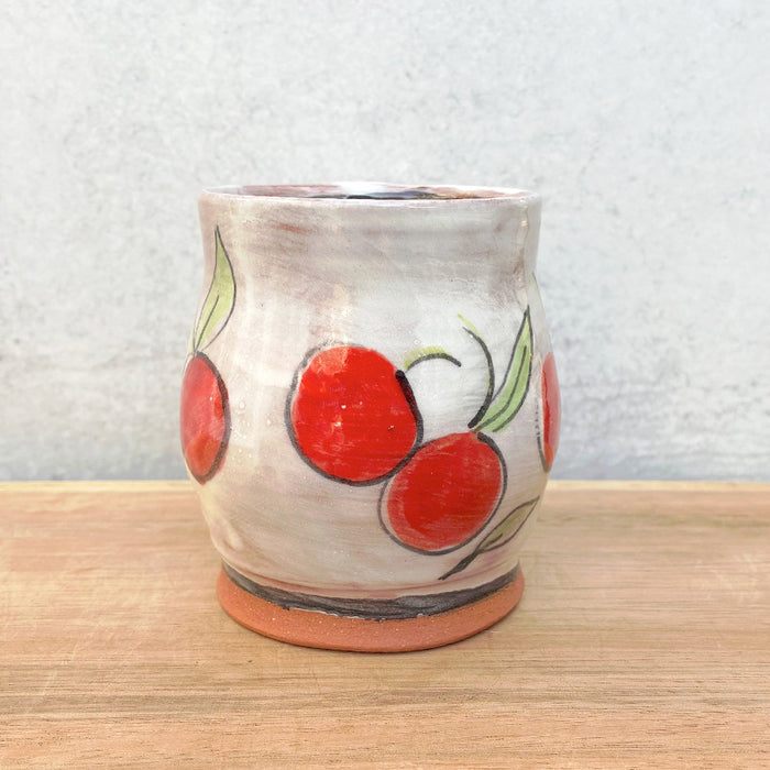 Handmade ceramic mug by NC potter Molly Lithgo. White with cherry decoration. View 2.
