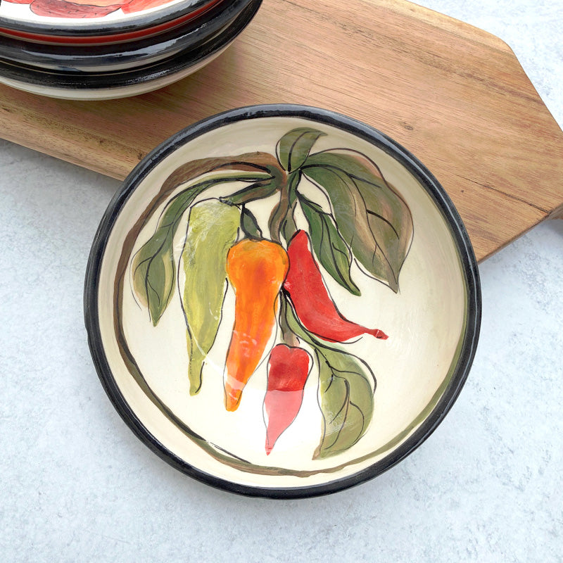 Handmade ceramic bowl with red, orange and green chili pepper decoration by Molly Lithgo.