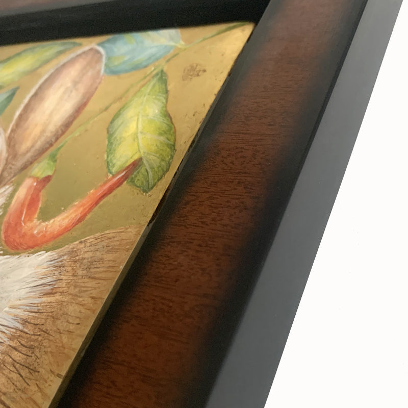 Garden Interloper painting by Diane Savino, a rabbit is surrounded by foliage and red peppers. Set in a brown and black frame, shown on a light blue wall. Frame detail shown.