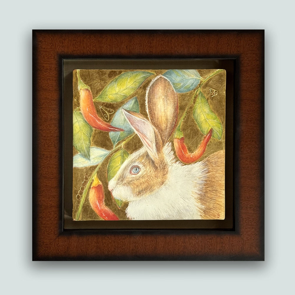 Garden Interloper painting by Diane Savino, a rabbit is surrounded by foliage and red peppers. Set in a brown and black frame, shown on a light blue wall.