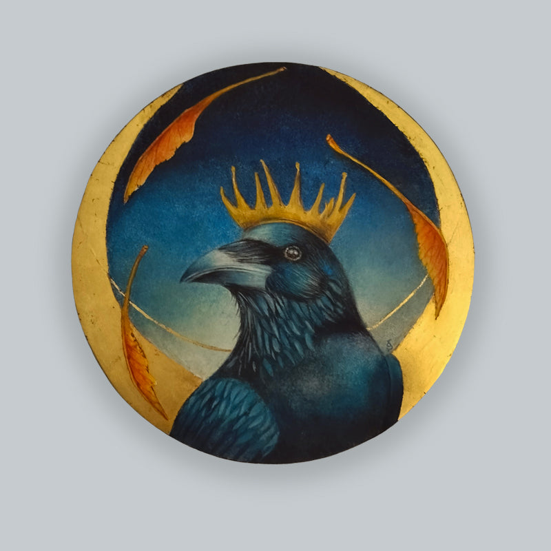 An 8" circular painting of a crown with golden crown, against a night sky with gold leaf details by Diane Savino. Shown on a pale grey wall. 