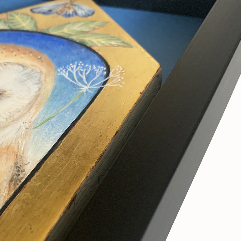 Sanctuary painting by Diane Savino, an owl sits inside a vignette on a house shaped form with foliage and a moth on top. Detail shown.