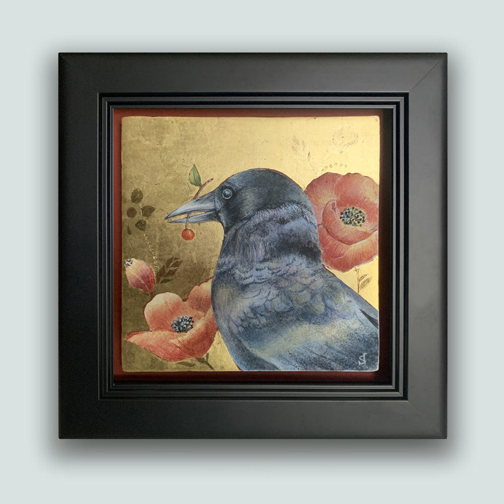 "The Bearer" painting by Diane Savino. A crow sits among red flowers with a gold background and black frame. The artwork is showcased on a pale blue wall.