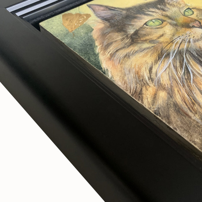 Under the Hunter Moon painting by Diane Savino, a cat sits under a golden moon and is surrounded by moths. Framed in black, detail shown.