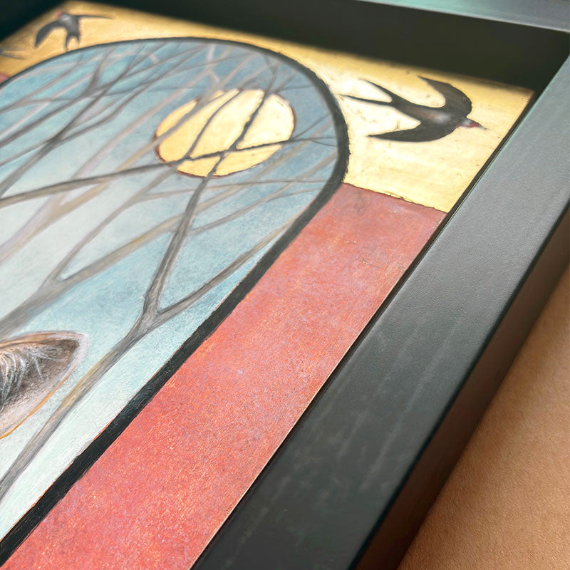 Illustrative egg tempera and gold leaf painting featuring a gray wolf in the foreground, an arched window-like scene with bare trees and a golden moon, two birds at the top, and red-orange side panels. The artwork, by Diane Savino, is set in a dark brown frame. Detail shown.