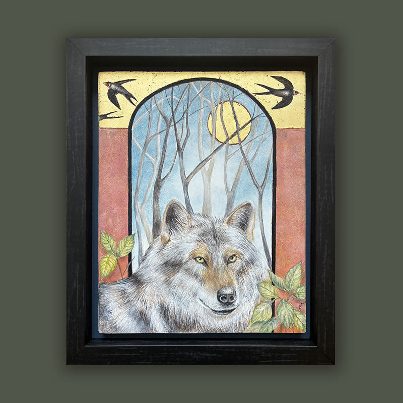 Illustrative egg tempera and gold leaf painting featuring a gray wolf in the foreground, an arched window-like scene with bare trees and a golden moon, two birds at the top, and red-orange side panels. The artwork, by Diane Savino, is set in a dark brown frame and displayed on dark green wall.