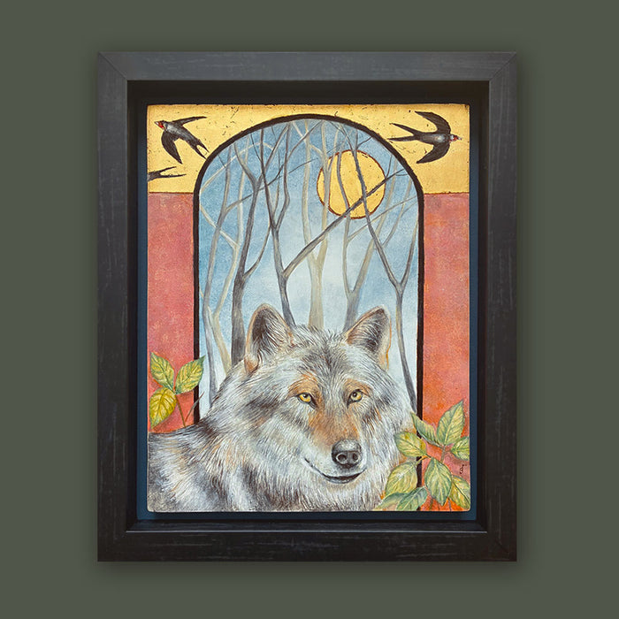 Illustrative egg tempera and gold leaf painting featuring a gray wolf in the foreground, an arched window-like scene with bare trees and a golden moon, two birds at the top, and red-orange side panels. The artwork, by Diane Savino, is set in a dark brown frame and displayed on dark green wall.