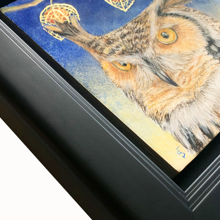"Night's Awakening" painting by Diane Savino. A great horned owl sits under a brilliant blue night sky with crescent moon. A branch with three Chinese lantern flowers hangs overhead. The egg tempera and gold leaf painting is set in a black frame. This image shows a frame detail.