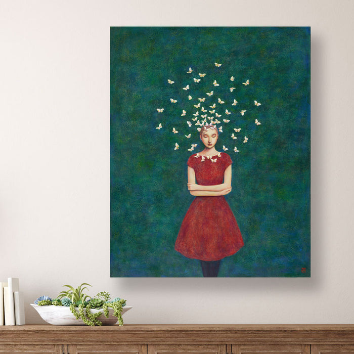 Circle of Serenity, Duy Huynh's  painting of a woman in a red dress standing with arms crossed, with a circle of  butterflies circling her head. The mottled dark teal and blue background is filled with subtle botanical textures. Displayed over wood console table.