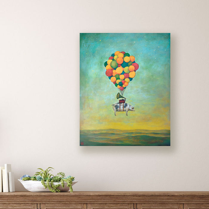 Suspension of Disbelief painting by Charlotte NC artist Duy Huynh. Surreal artwork of a pig, with a gramophone on its back, being carried through the sky by a cluster of colorful balloons. The background is a dreamy gradient sky transitioning from teal-blue to warm yellow and dark green mountain landscape below. The painting is displayed over a wood console table. 