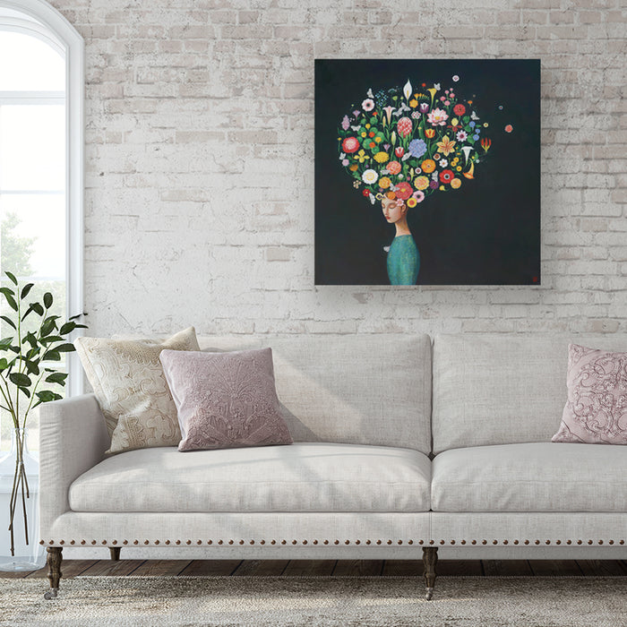 Thoughtful Garden by Duy Huynh, a painting of woman with a head full of colorful flowers on a dark background. Displayed over a sofa.