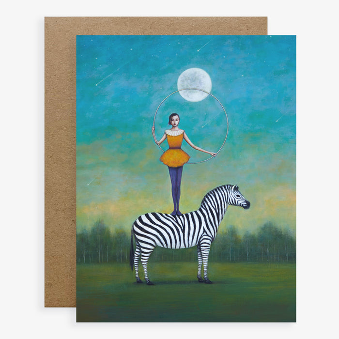 Duy Huynh notecard "Between the Stars and Stripes".  A woman stands, holding a hoop, on top of a zebra under a night sky and full moon. Card is blank inside.