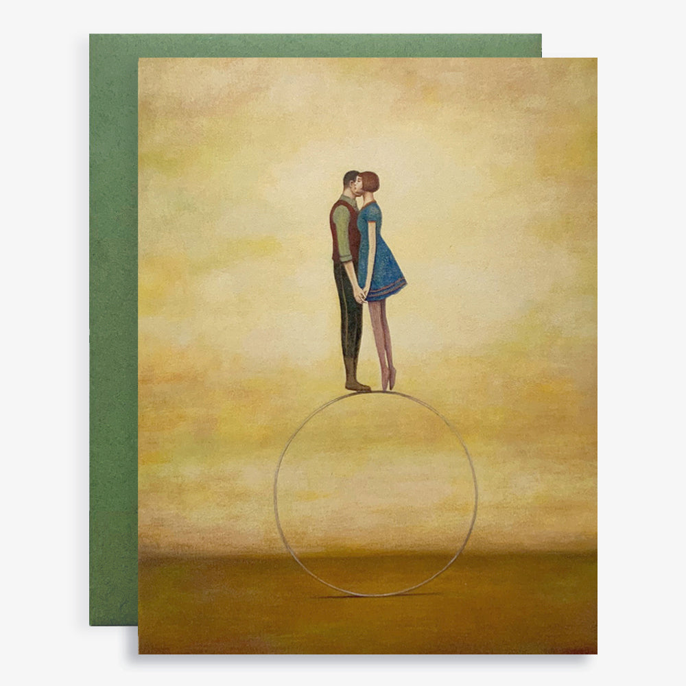 Duy Huynh notecard "Whisper". A couple embrace, balancing on top of a hoop. Card is blank inside. 