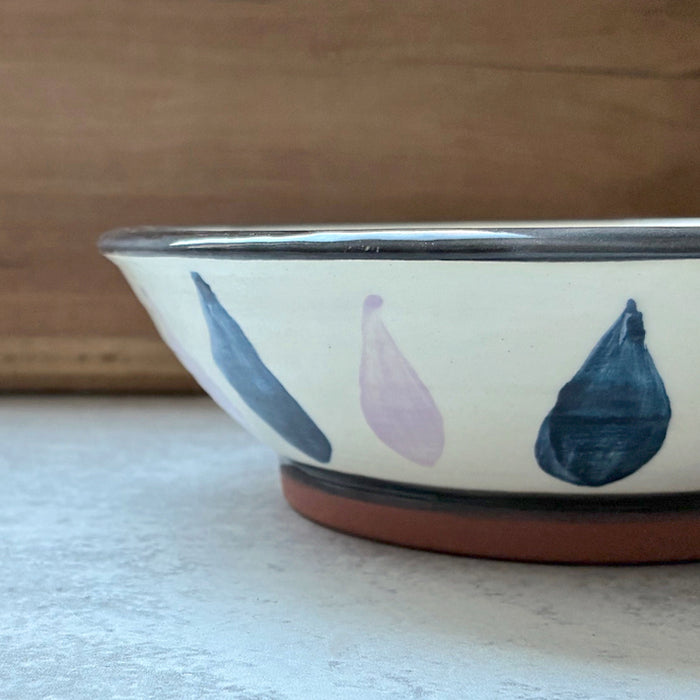 Handmade ceramic bowl with eggplant decoration by Molly Lithgo. Side view.