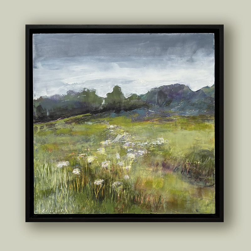 Oil and cold wax painting by North Carolina artist Elizabeth Davant depicting a lush green Blue Ridge Mountain landscape with a field of flowers. Set in a black frame and shown on a pale green wall. 