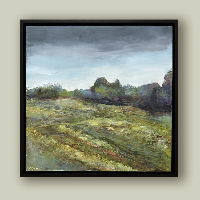 Oil and cold wax painting by North Carolina artist Elizabeth Davant depicting a Blue Ridge Mountain tree landscape under cloudy skies. Set in a black frame and shown on pale green wall.