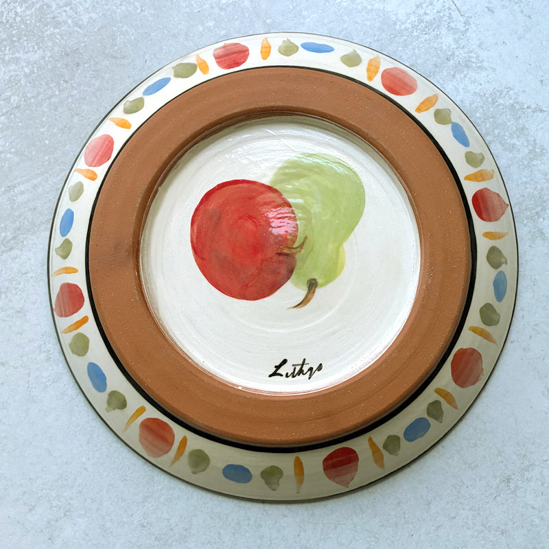 Handmade ceramic serving bowl with apple, pear and grape decoration by Molly Lithgo. Bottom view.