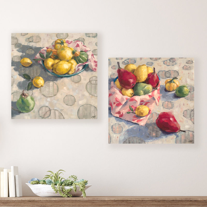 Two 16 x 16" oil still life paintings by Ninalee Irani that feature a vibrant medley of fruits and vegetables.  Photo shows paintings displayed together on a wall, above a table. 
