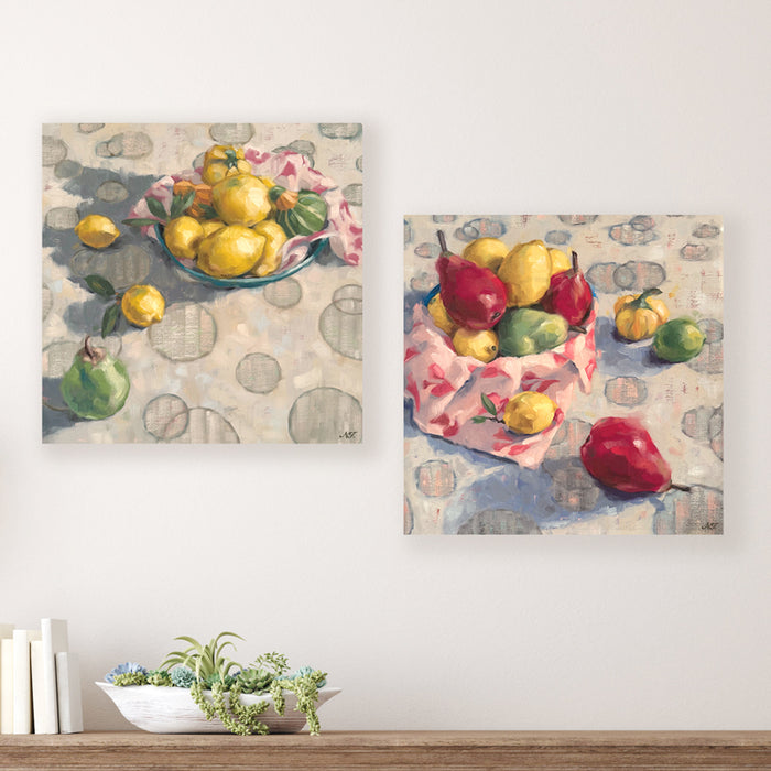 Two 16 x 16" oil still life paintings by Ninalee Irani that feature a vibrant medley of fruits and vegetables.  Photo shows paintings displayed together on a wall, above a table. 