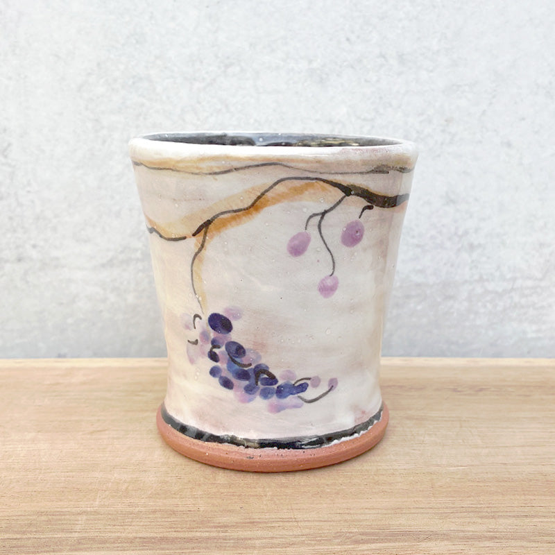 Handmade ceramic cup by NC potter Molly Lithgo. White with grapevine decoration. 