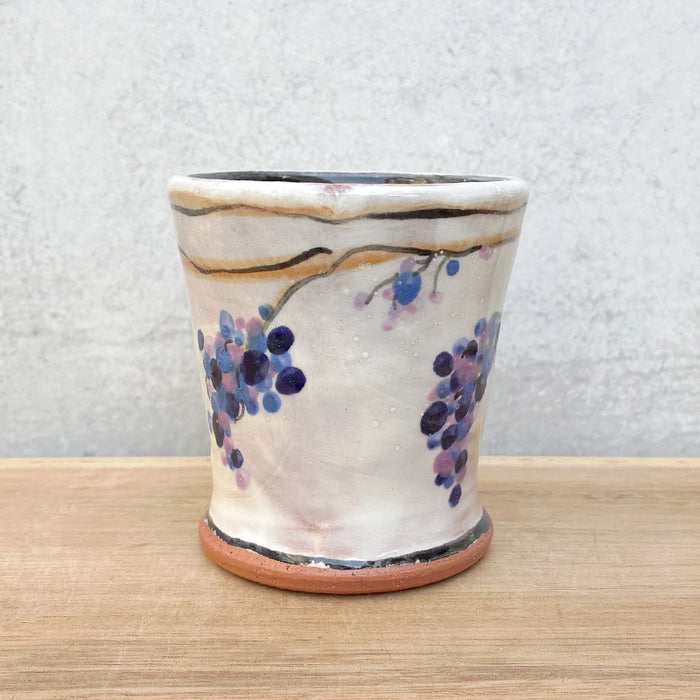 Handmade ceramic cup by NC potter Molly Lithgo. White with purple grapevine decoration. 