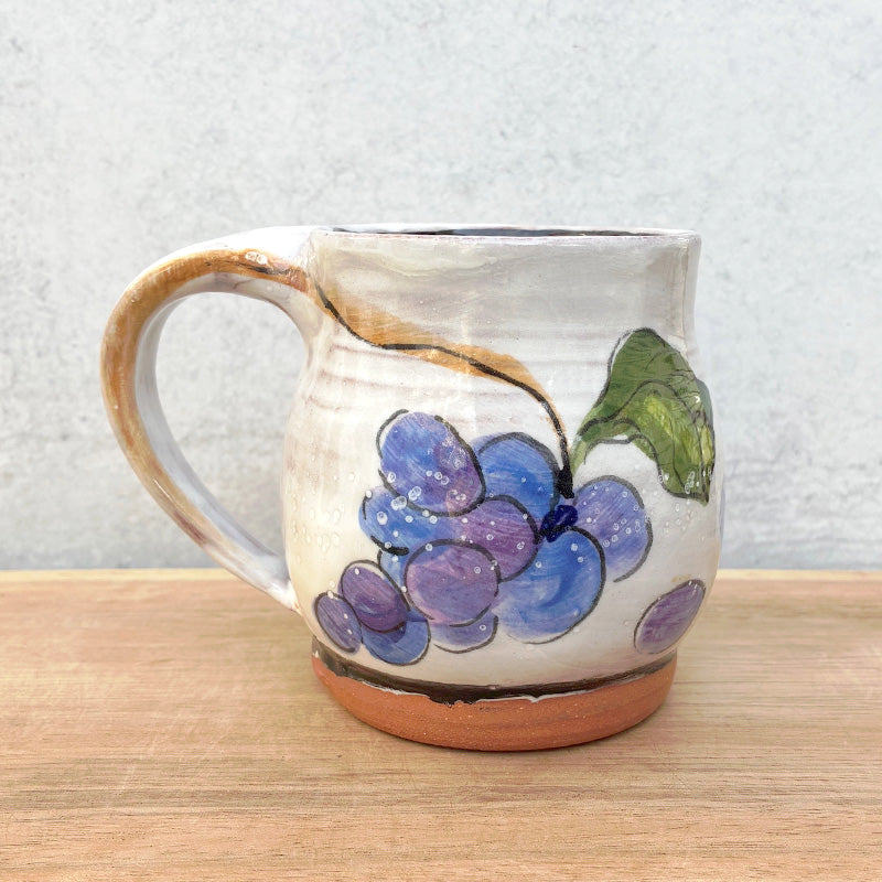 Handmade ceramic mug by NC potter Molly Lithgo. White with grapes decoration. 