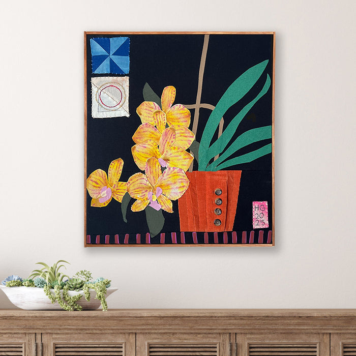 Yellow Orchids, Hannah Goff mixed media textile artwork. Orange flower pot with yellow orchid plant against black background with geometric details. Displayed over table. 