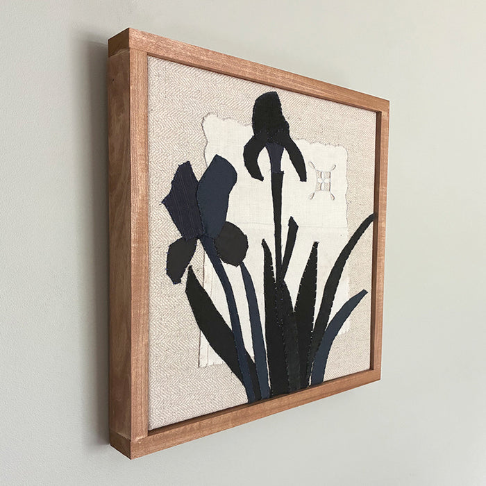 Framed textile artwork of black irises on cream background, by Hannah Goff.