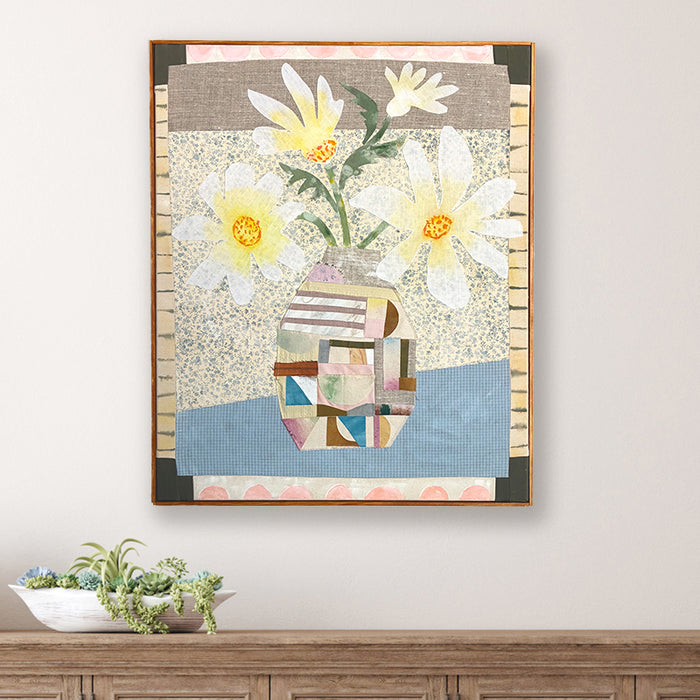 Patchwork Daisies by Hannah Goff, mixed media textile artwork with patchwork vase filled with daisies, wood frame. Shown on white wall. 