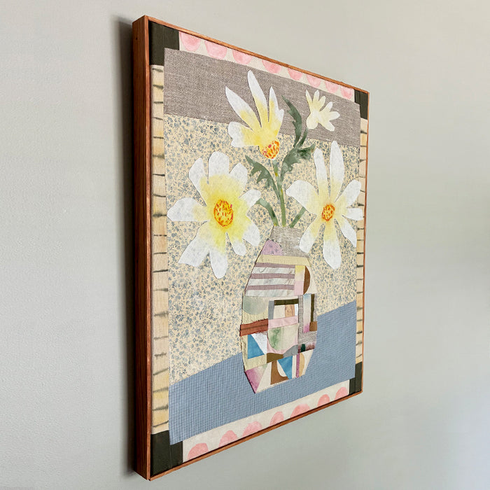Patchwork Daisies by Hannah Goff, mixed media textile artwork with patchwork vase and white daisies. Side view on wall. 