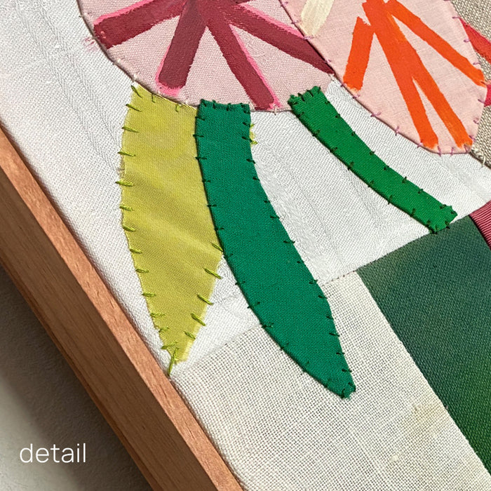 Artwork by Hannah Goff. Mixed media textile painting with geometric vase and colorful abstracted flowers. Wood frame detail. 