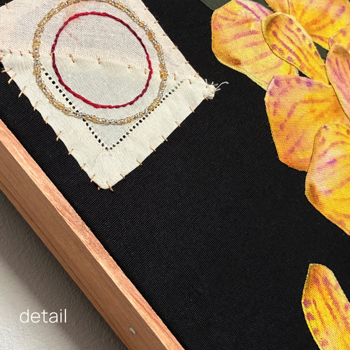 Yellow Orchids, Hannah Goff mixed media textile artwork. Orange flower pot with yellow orchid plant against black background with geometric details. Close up detail with frame. 