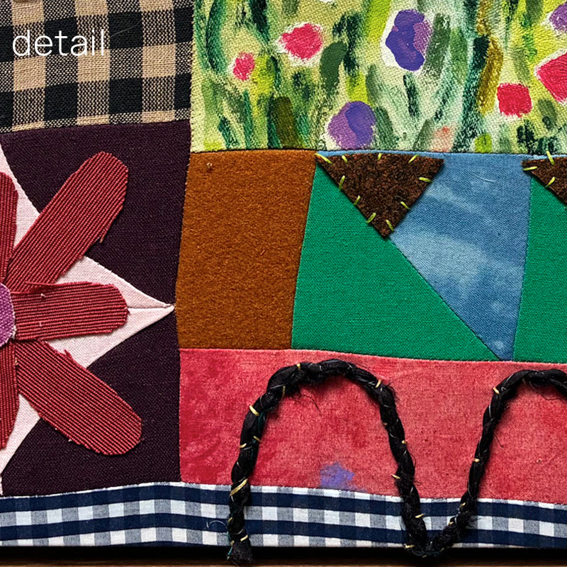 Poppy Patchwork, multicolored floral mixed media textile artwork by Hannah Goff with handmade wood frame. Detailed photo. 