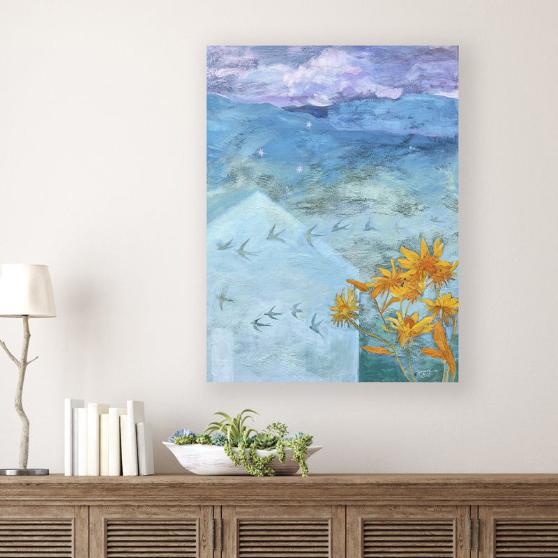 "Call it Dreaming" artwork by Western NC based artist Hannah Seng. Soothing mountain dreamscape in blues and purples, with barn swallows in flight and yellow flowers blooming in the foreground. Shown on white wall.