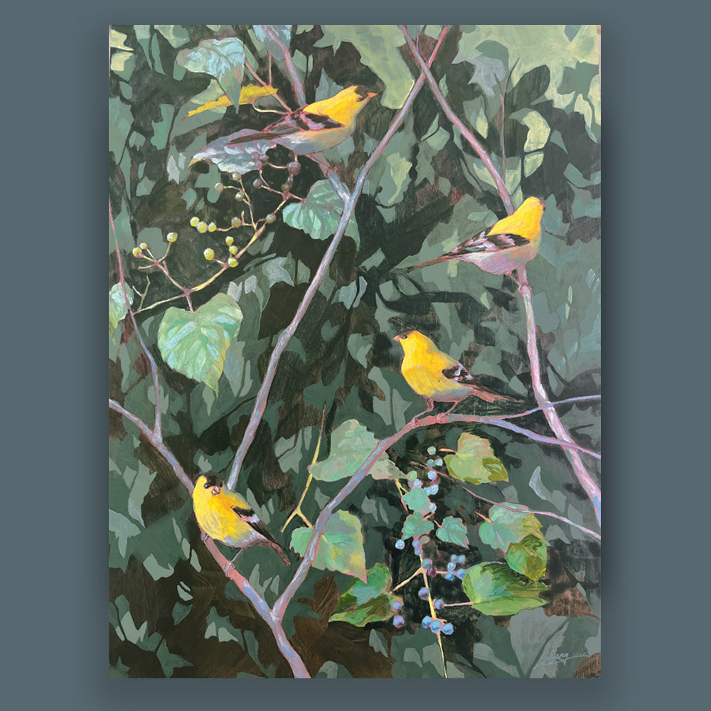 Hannah Seng's "In This Family Tree" painting, four yellow goldfinches perched among bitter vine branches with green foliage. Shown on dark blue wall.