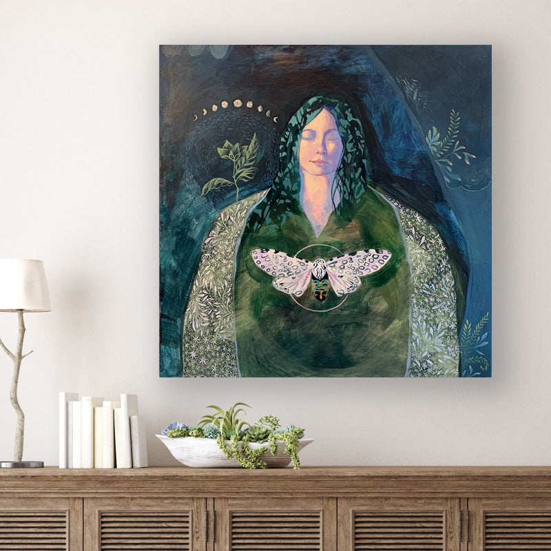 "The Soft Language of Darkness" acrylic painting by Western NC based artist Hannah Seng. The artwork, in rich blues and greens, features a woman, a giant leopard moth, various mosses and the moon phases. Shown on white wall.