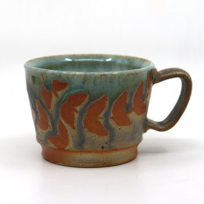 Handmade, wood-fired stoneware mug with botanical design by Heather Ossandon.