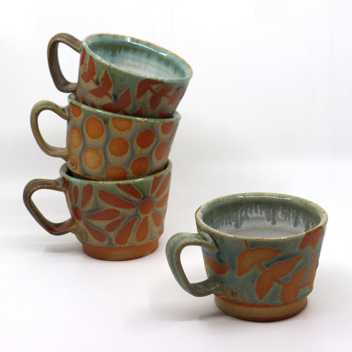 Handmade wood-fired stoneware mugs by Heather Ossandon.