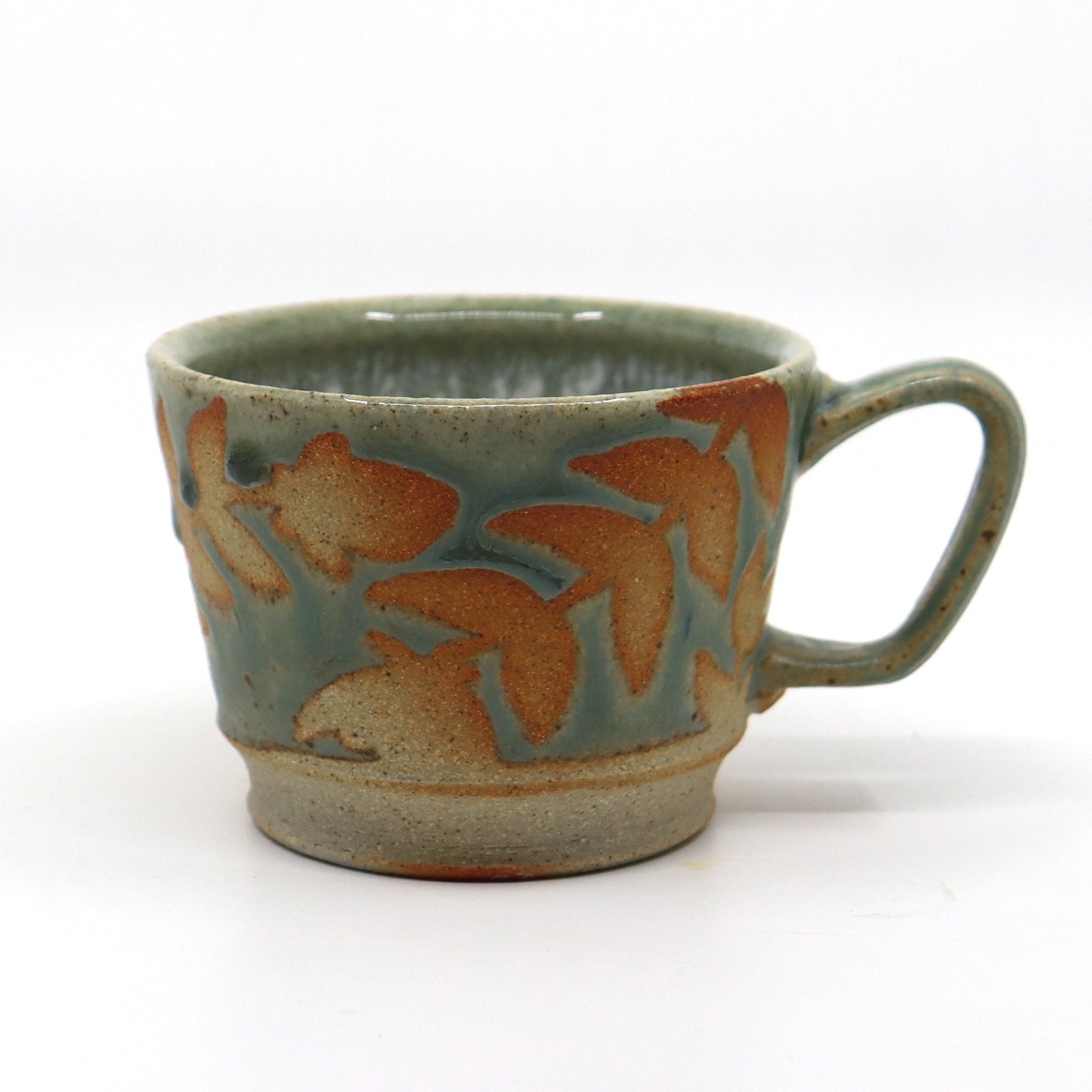 Handmade wood-fired stoneware mug with botanical design by Heather Ossandon.