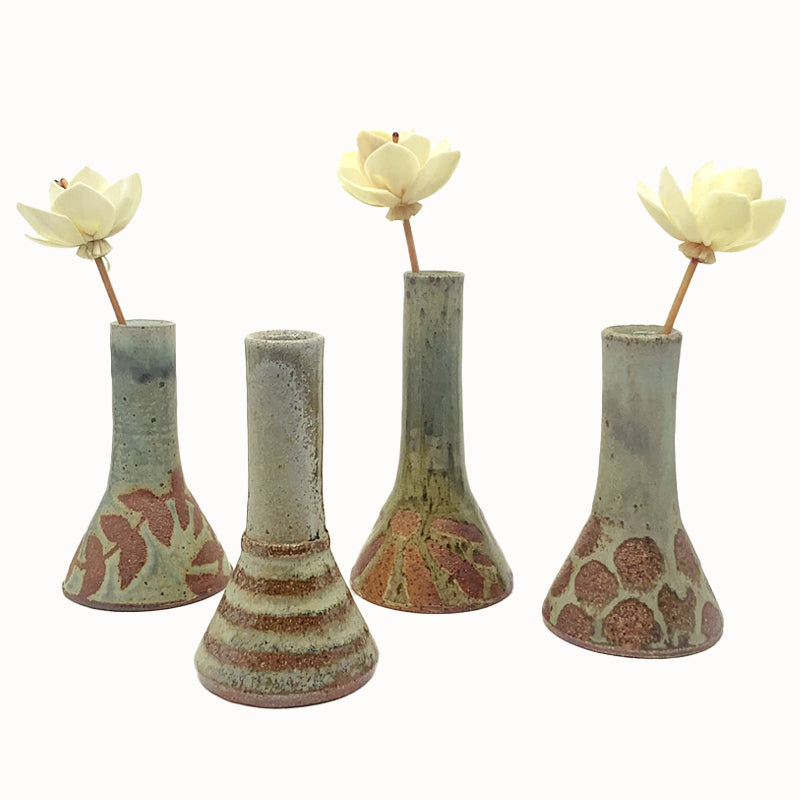 Wood-fired bud vases with wax resist patterns by Heather Ossandon. 