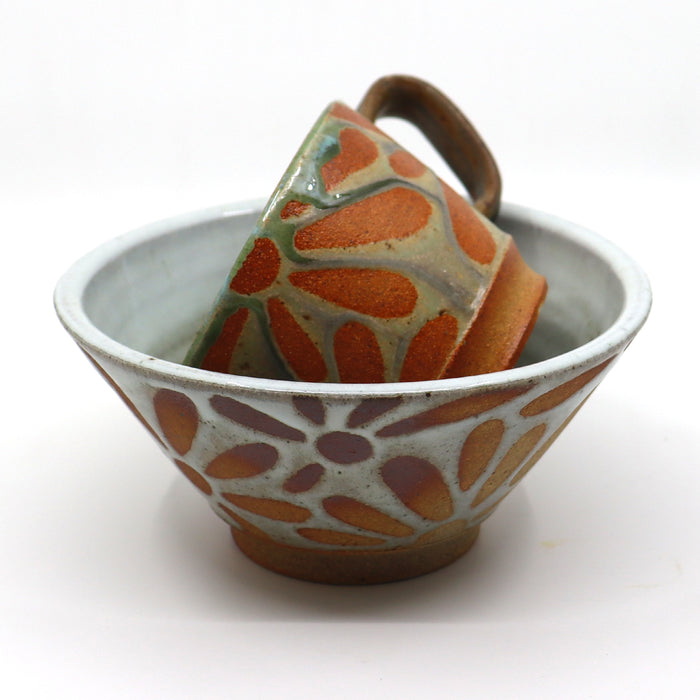 Handmade wood-fired ceramics with flower patterns by Heather Ossandon.