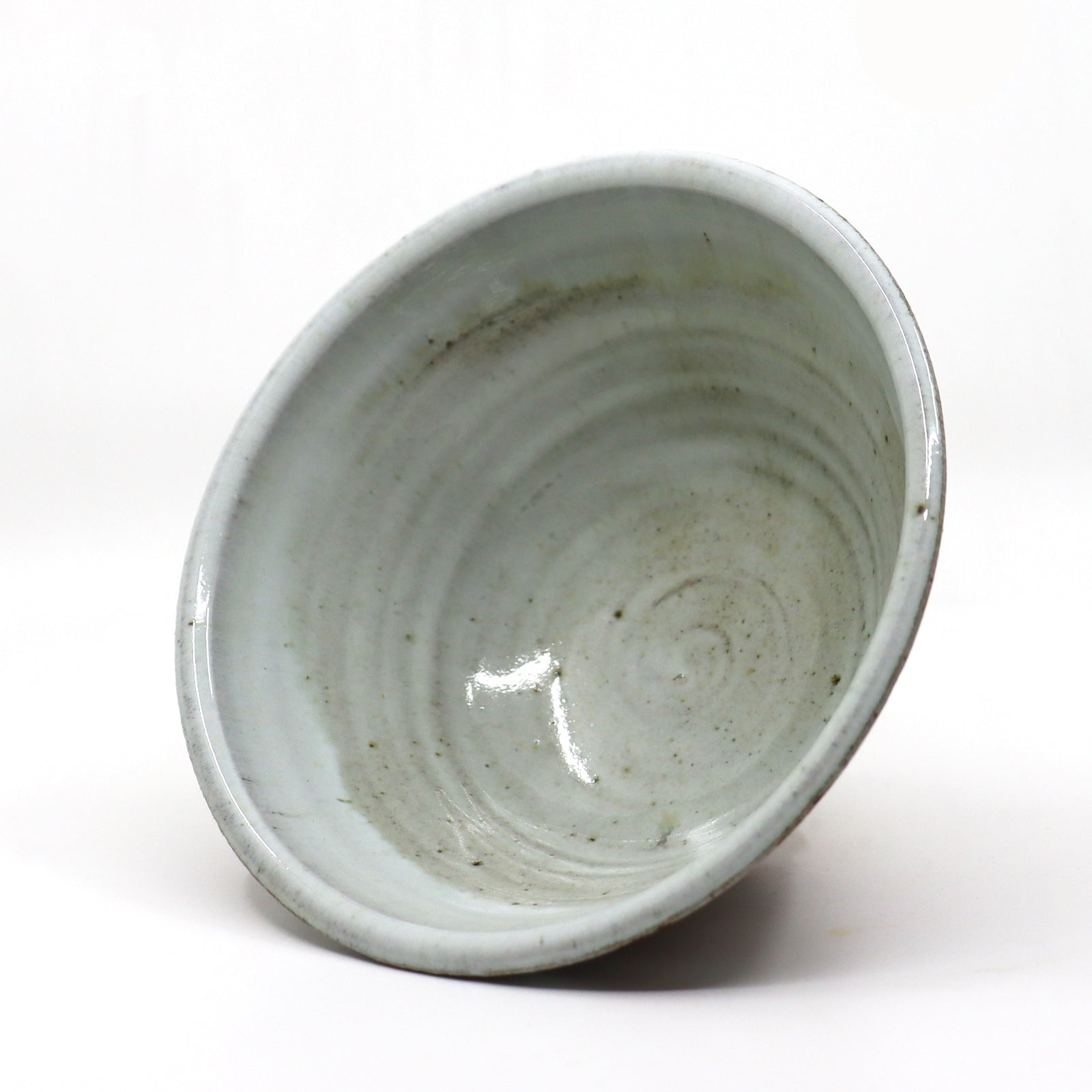 Interior view of handmade, wood-fired stoneware bowl with flower design by Heather Ossandon