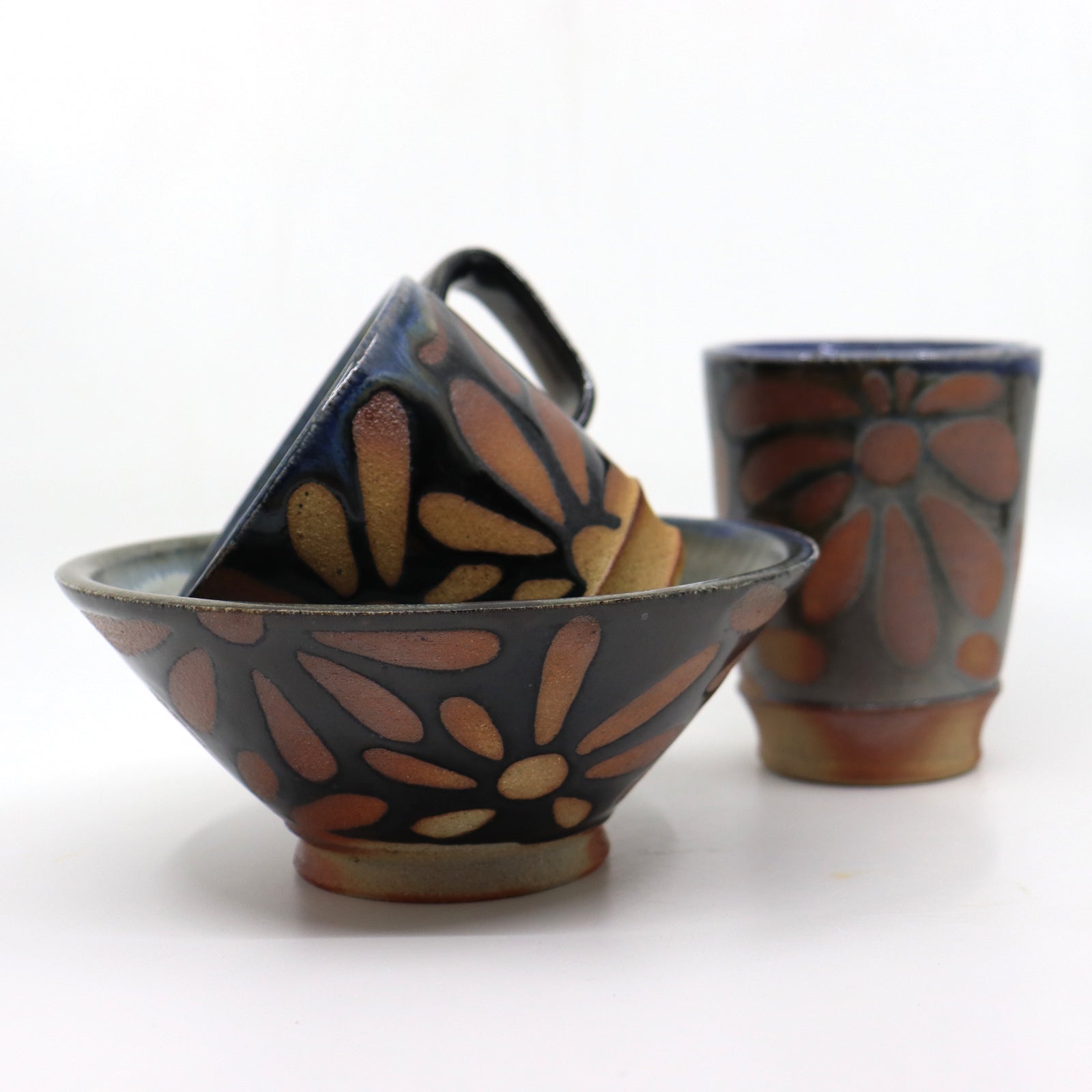 Handmade, wood-fired stoneware ceramics with flower patterns by Heather Ossandon.