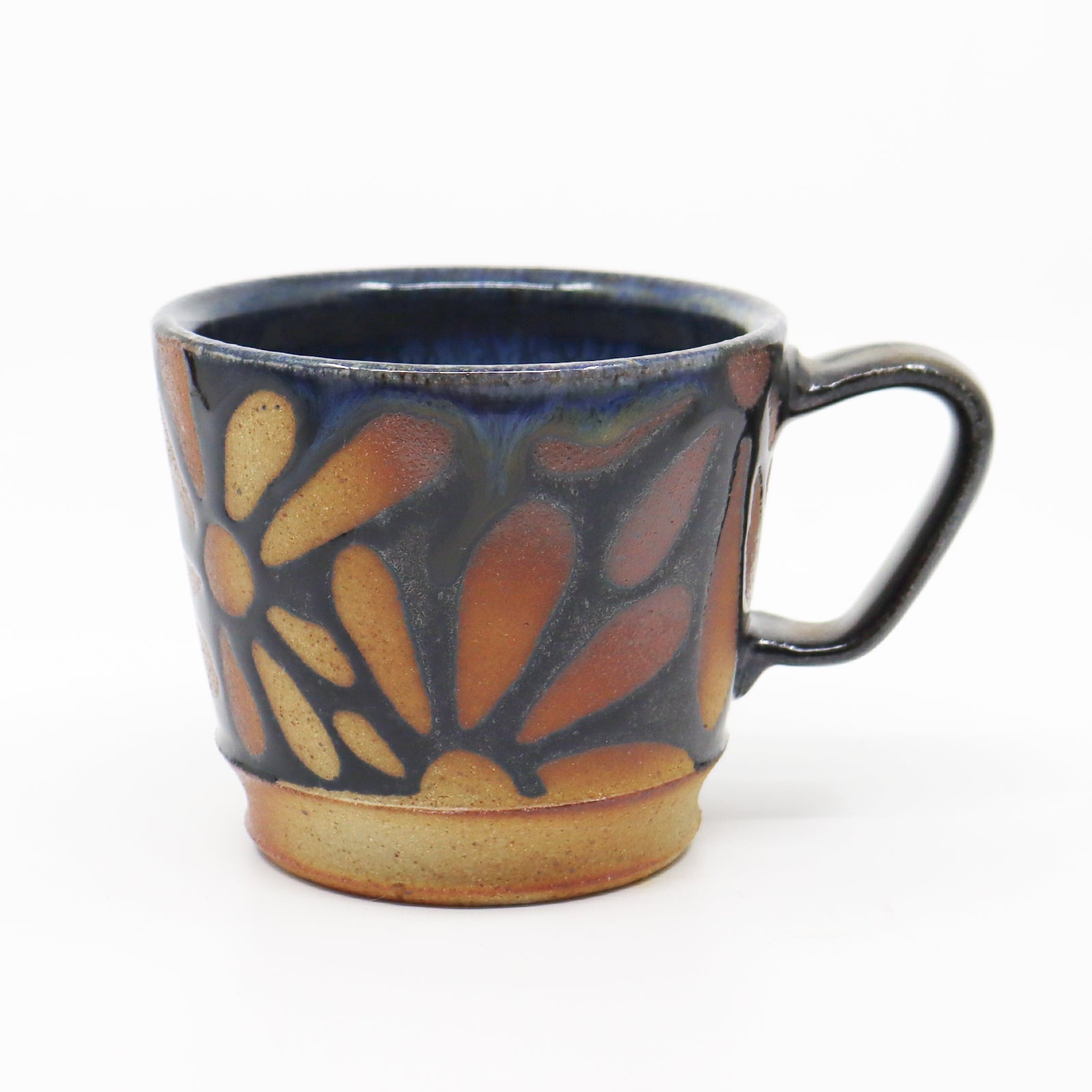 Handmade, wood-fired stoneware mug with flower pattern by Heather Ossandon.