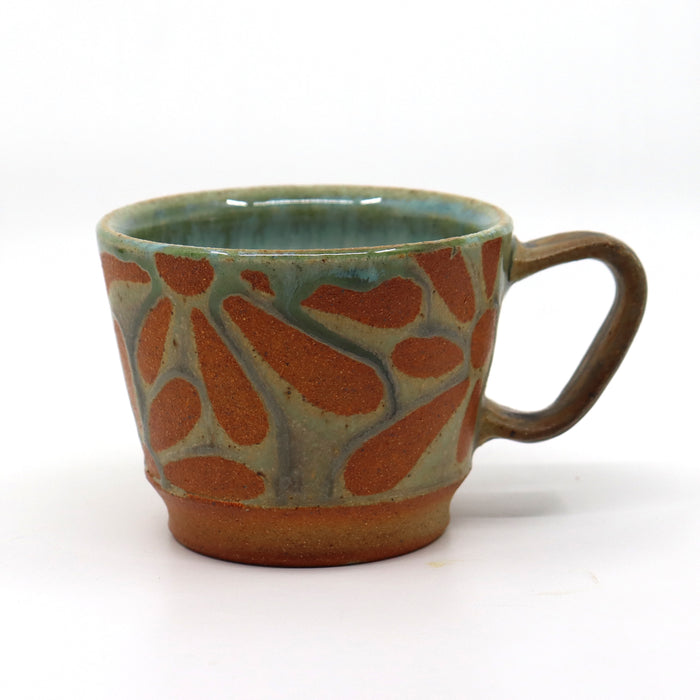 Handmade, wood-fired stoneware mug with flower pattern by Heather Ossandon.